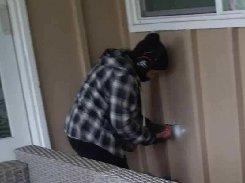 Professional electrician installing an exterior outlet in Freedom